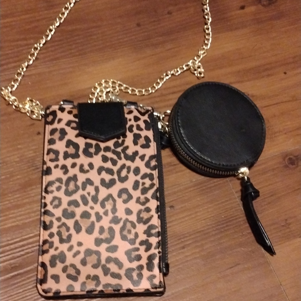 Cute little bag that holds your phone, cards, money and coins. Chain strap.